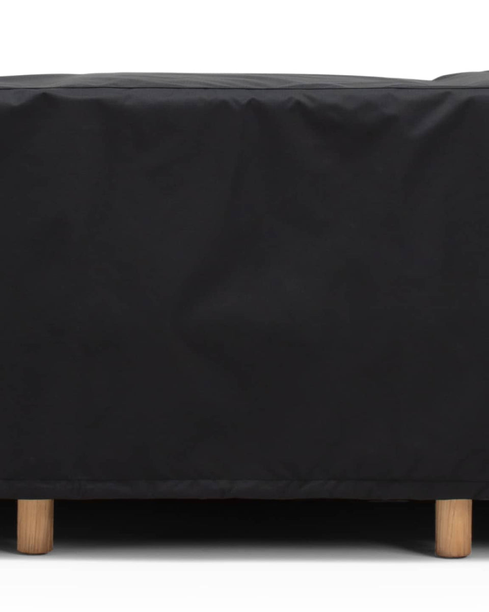 Outdoor sofa covered by a black protective cover