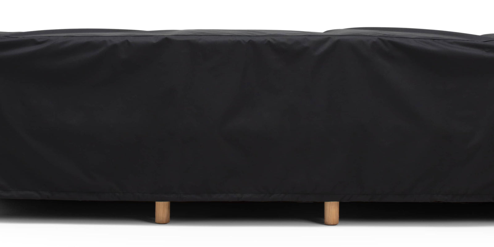 Outdoor sofa covered by a black protective cover