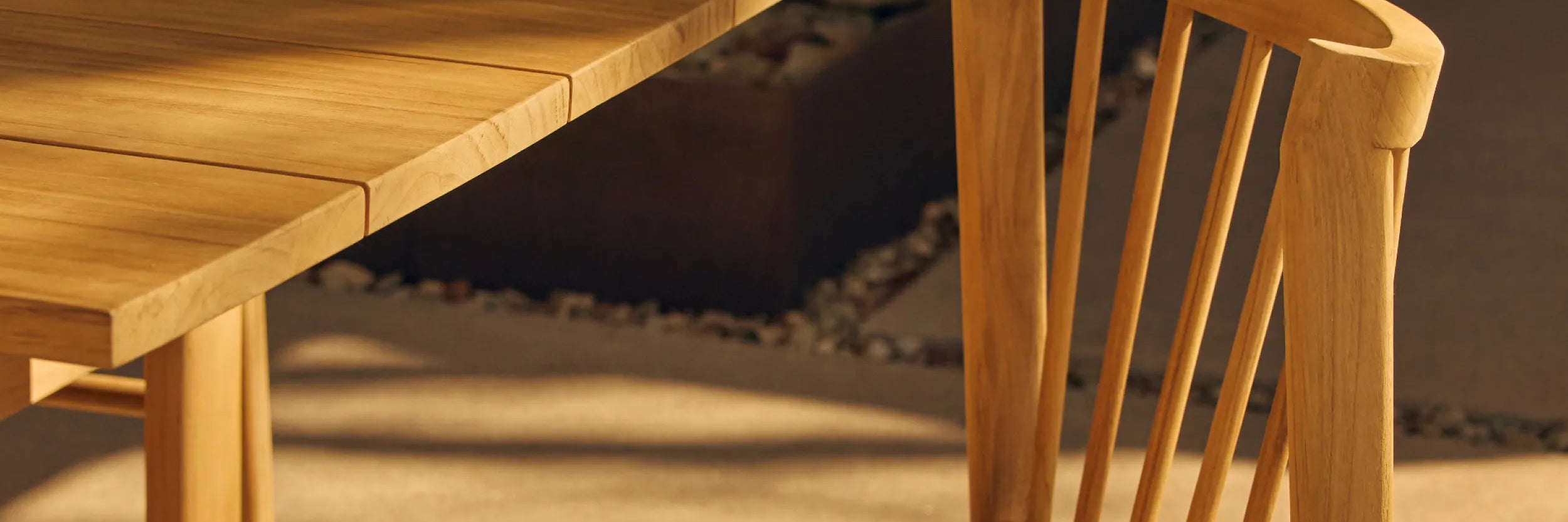 Teak outdoor dining chair next to teak dining table