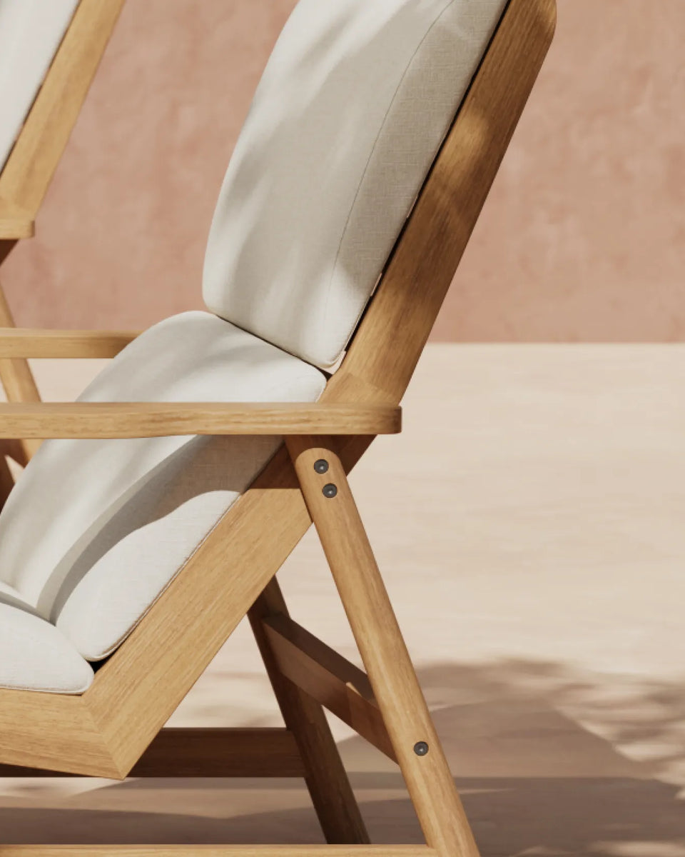 Two teak deck chairs with white cushions