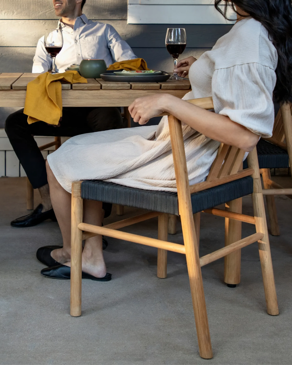 Couple sitting at a teak outdoor dining table