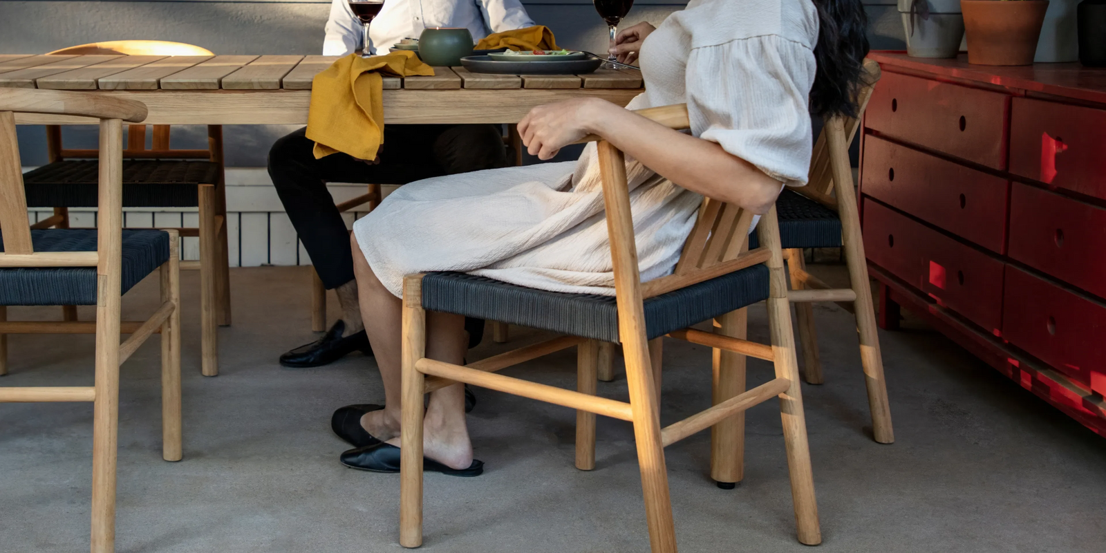 Couple sitting at a teak outdoor dining table