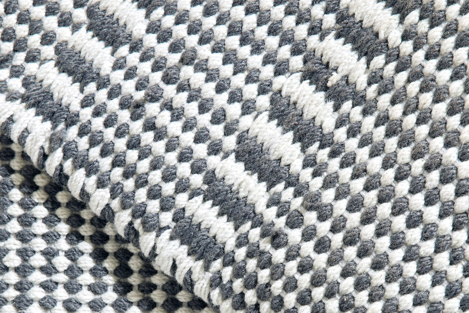 Closeup of Neighbor Field Outdoor Rug woven texture and pattern detail on patio