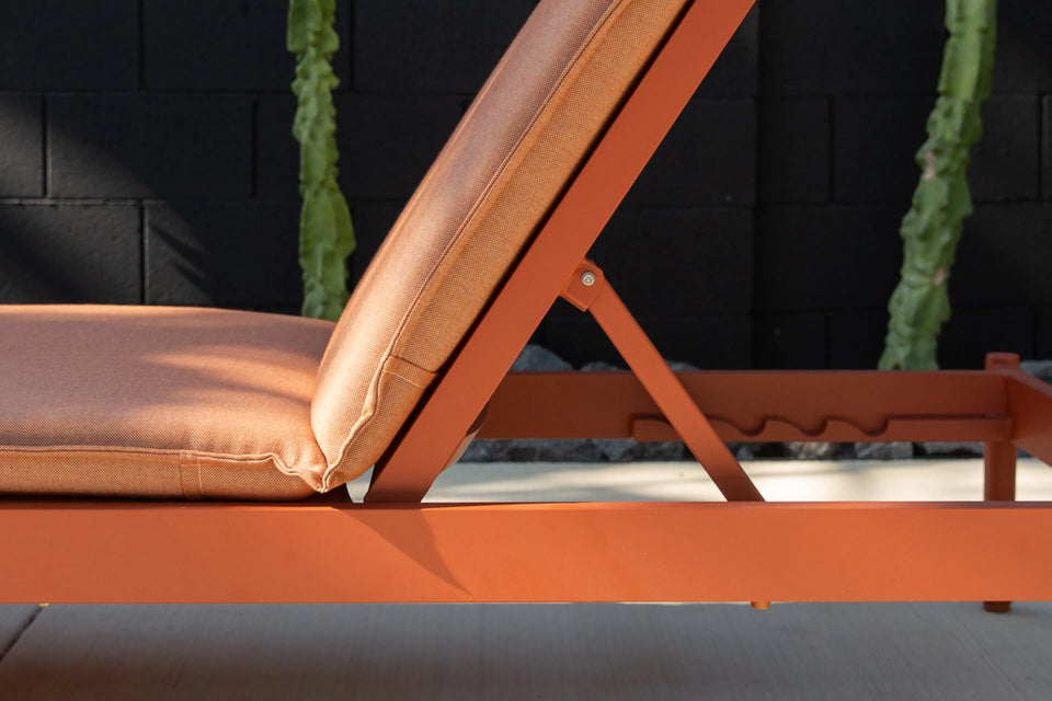 Neighbor Terra Sun Lounger with cream cushion and teak frame in outdoor poolside or patio setting