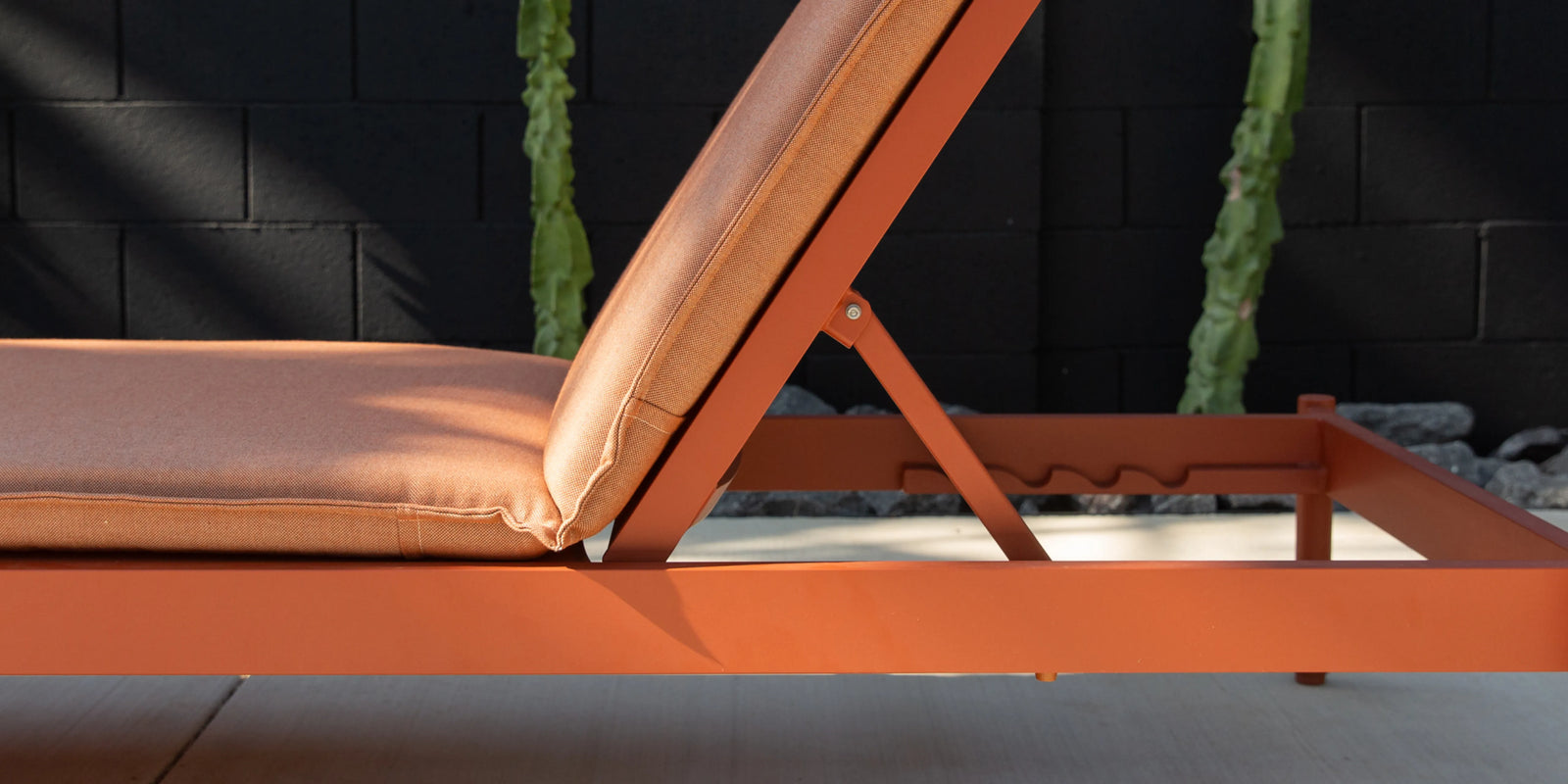 Neighbor Terra Sun Lounger with cream cushion and teak frame in outdoor poolside or patio setting