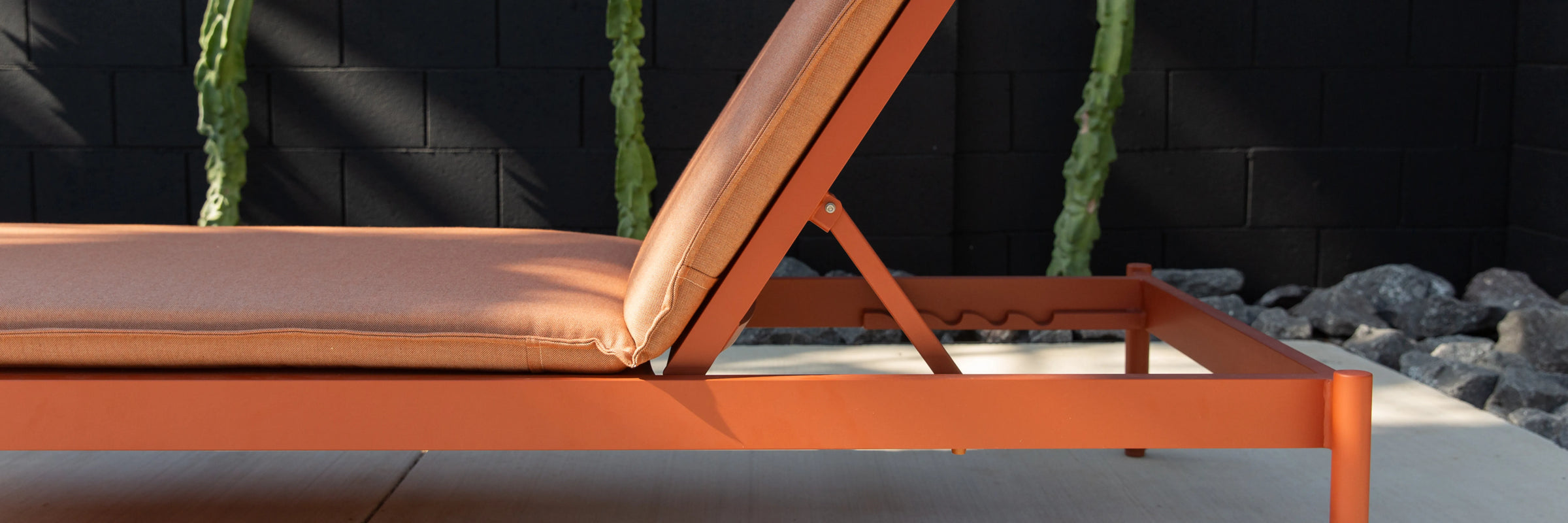 Neighbor Terra Sun Lounger with cream cushion and teak frame in outdoor poolside or patio setting