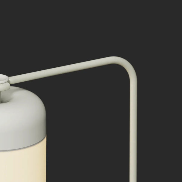 Arc arm attachment detail — closeup of Acorn Stand mounting joint in light gray finish against dark background