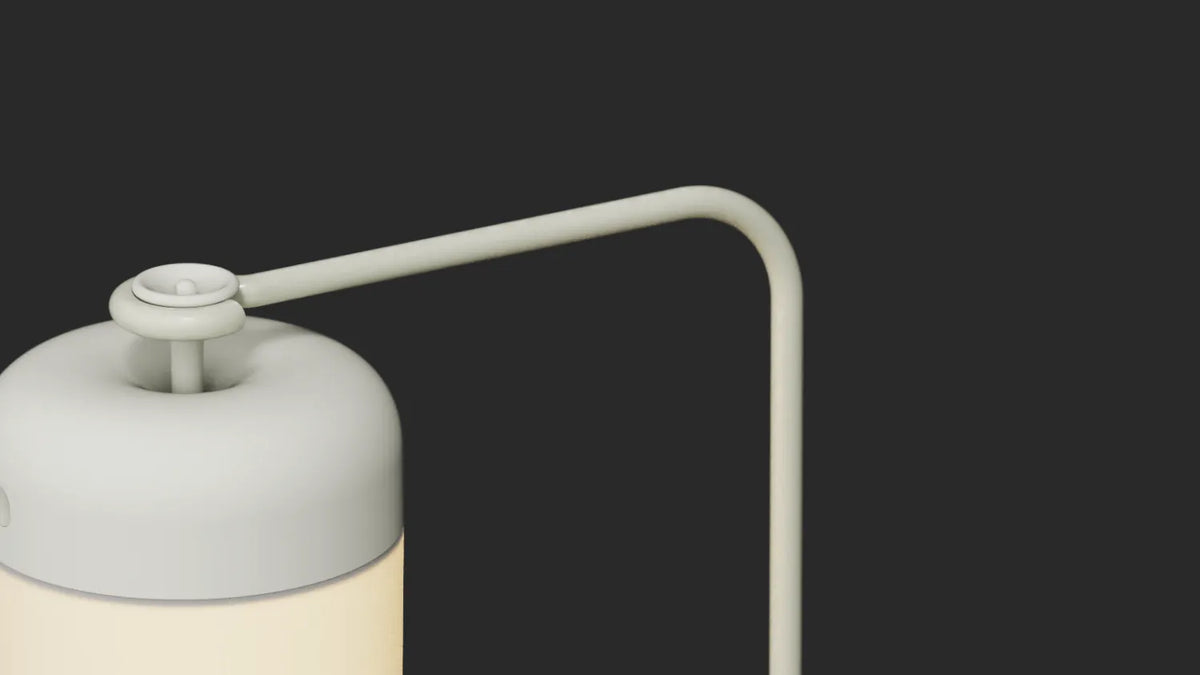 Arc arm attachment detail — closeup of Acorn Stand mounting joint in light gray finish against dark background