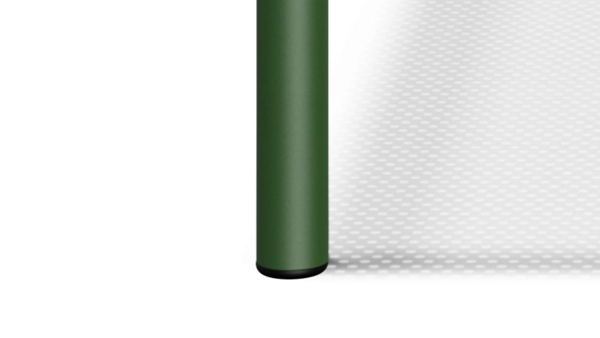 Cylindrical leg and rubber foot detail — closeup of Perf Chair leg in forest green with black rubber foot on white background