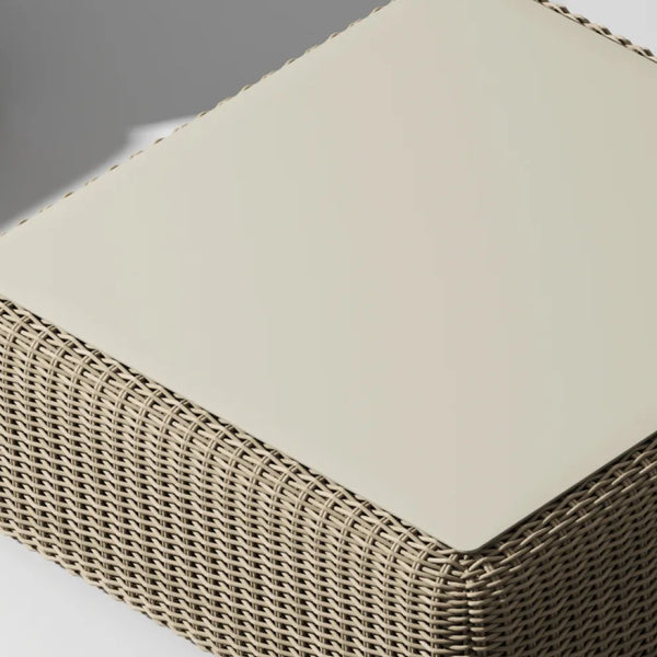 Roundabout Ottoman in natural wicker with flat cream tray top — angled overhead view on gray background