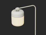 Neighbor Acorn Lantern Stand in putty finish with warm glow, displayed on dark surface