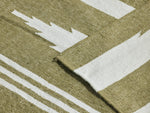 Neighbor Mesa Rug in Basil, detail showing olive green and cream striped geometric woven pattern with fold