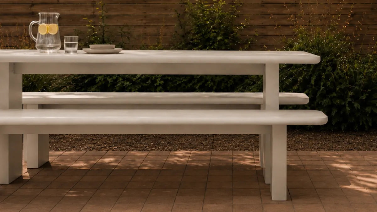 Massif Dining Set in ivory concrete composite: monolithic table with two integrated benches on thick slab legs.