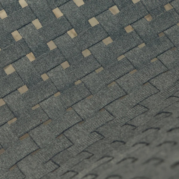 Extreme close-up macro of the Neighbor Up-Down Chair's charcoal woven-strap seat showing the herringbone-style basket weave, with subtle natural-tone fibers peeking through the dense grid pattern.