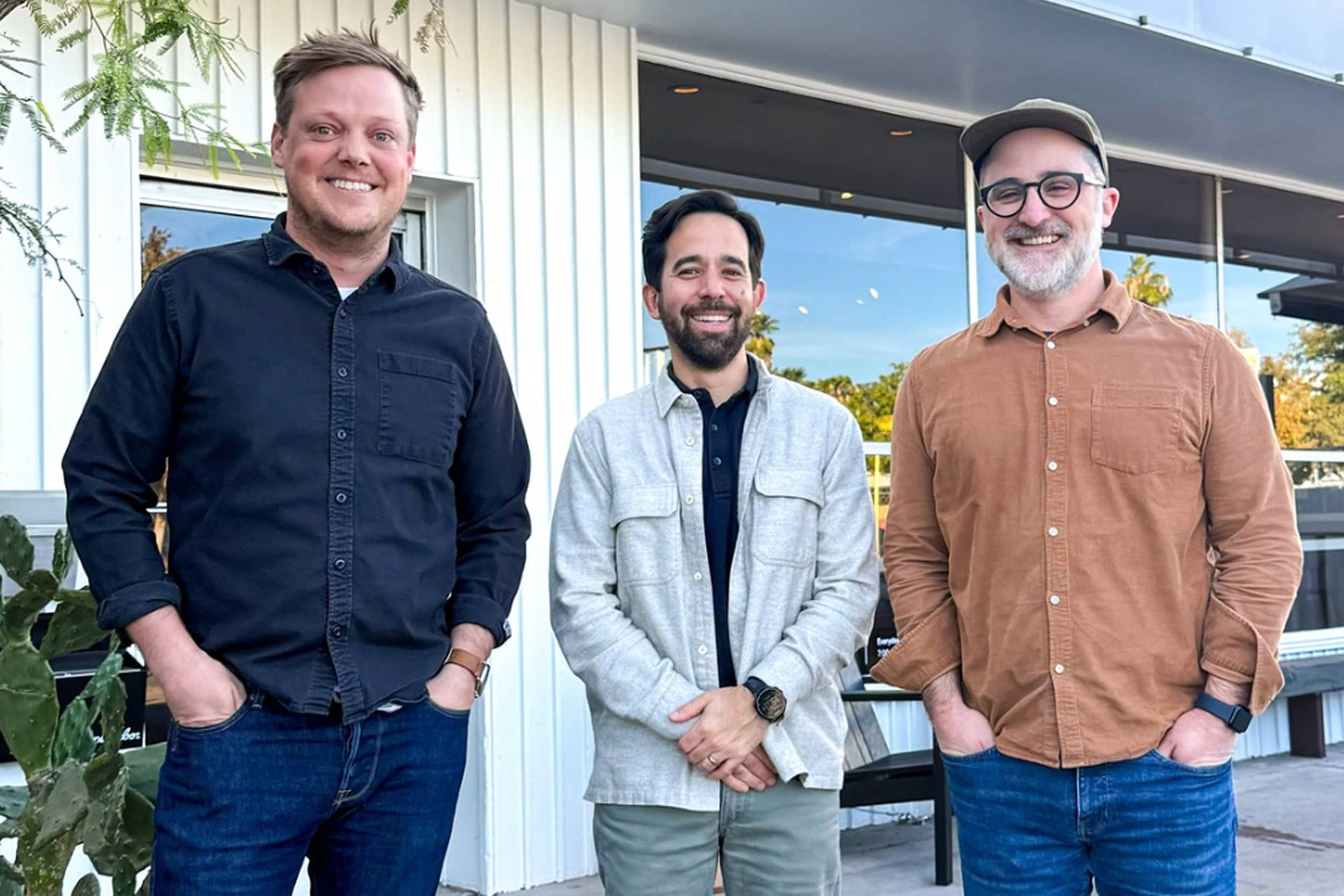 Three Neighbor co-founders standing outdoors in front of a white building