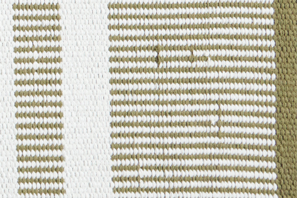 Close-up flat lay of Neighbor Dune rug in hand-woven olive and cream stripe texture