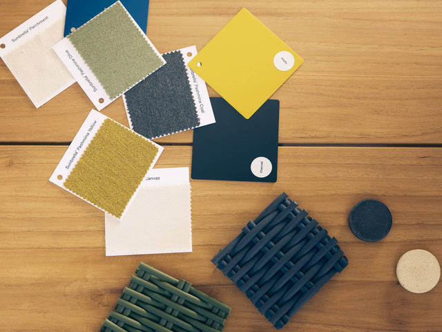 Flat lay of Neighbor material and color swatches on teak - Sunbrella fabrics, polywood tiles, wicker cord, and concrete discs