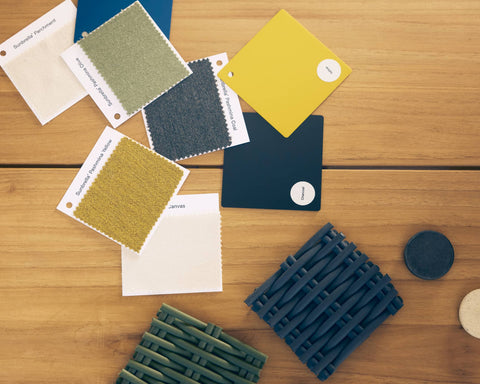 Flat lay of Neighbor material swatches on a teak surface including fabric, polywood, and woven cord samples